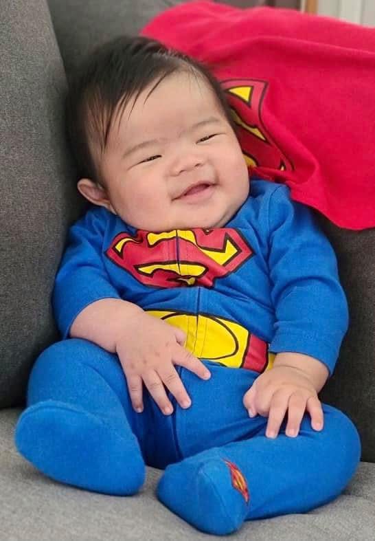 Baby sitting on a couch — life insurance protecting California families